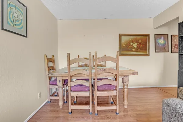 a dining room with furniture and wooden floor