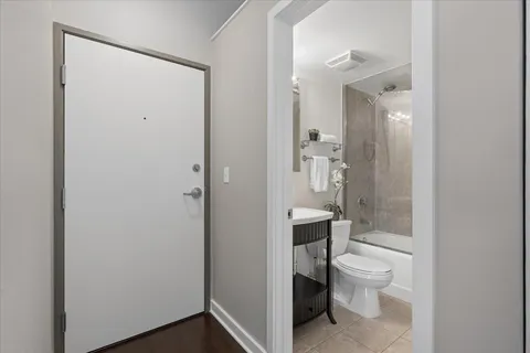 a bathroom with a toilet and a shower
