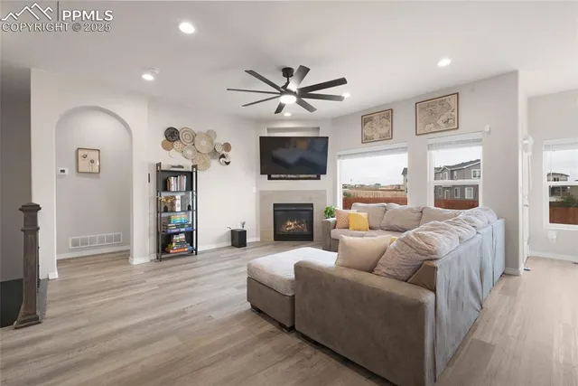a living room with furniture fireplace and flat screen tv