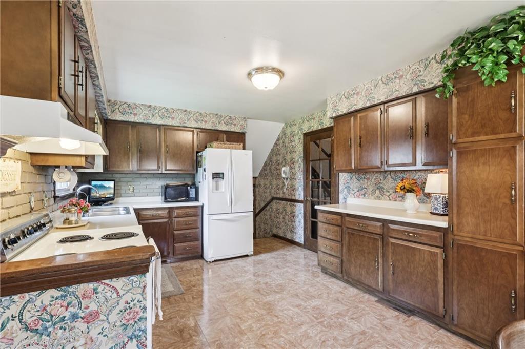 948 9th Street New Castle, PA 16101 - Photo 11 of 31 a kitchen with refrigerator and cabinets