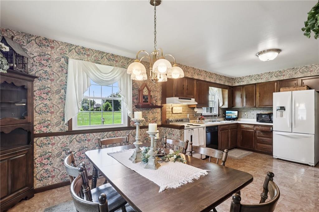 948 9th Street New Castle, PA 16101 - Photo 12 of 31 a dining room with furniture a kitchen and chandelier