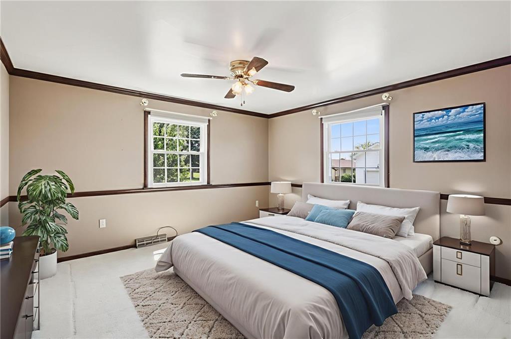 948 9th Street New Castle, PA 16101 - Photo 4 of 31 a bedroom with a large bed chandelier and a window