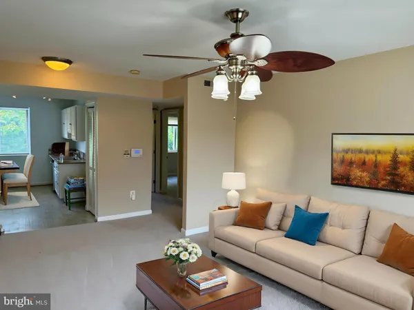 a living room with furniture a rug and a chandelier