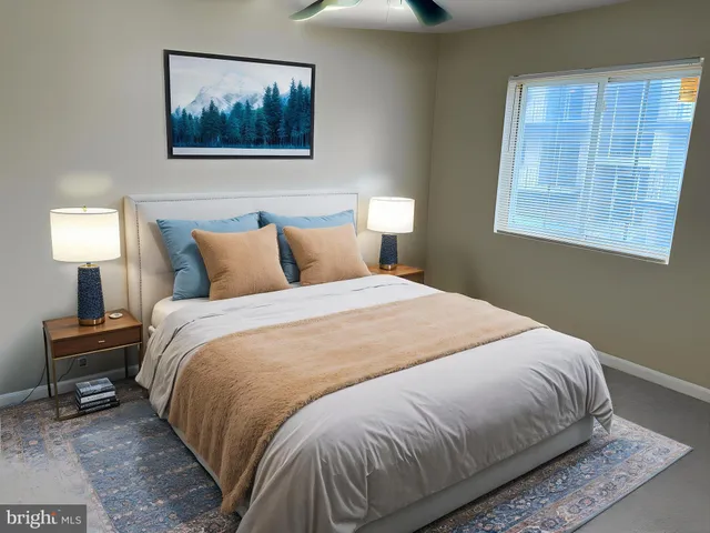 a bedroom with a bed and a lamp