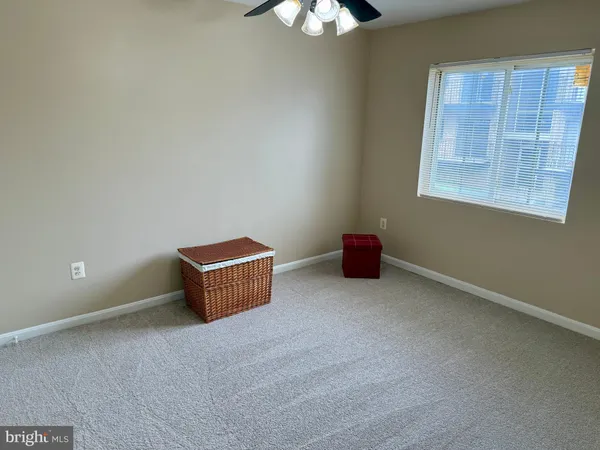 a room with a window and a chandelier