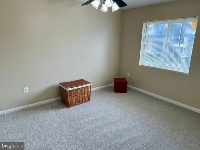 a room with a window and a chandelier