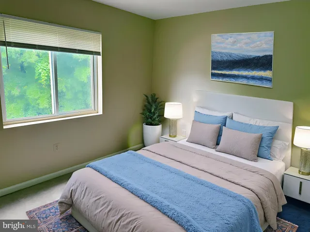 a bedroom with a bed and a painting on the wall