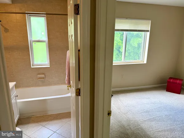 a bathroom with a tub and a window