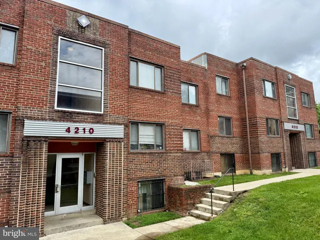 a front view of a brick house with a yard
