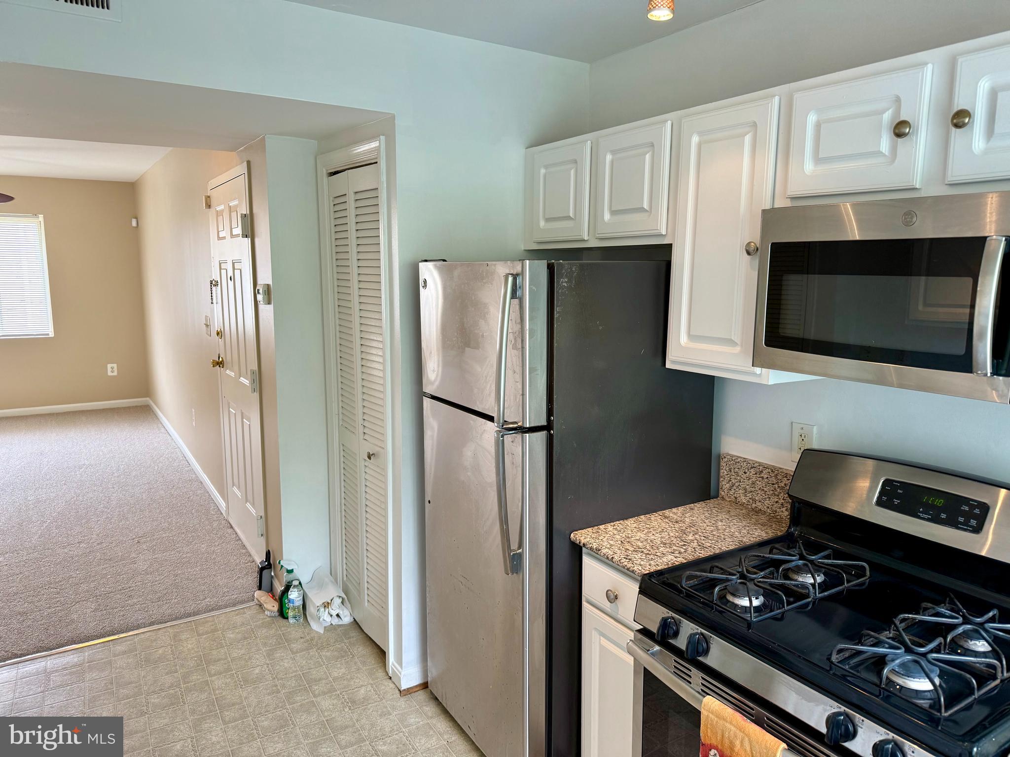 4212 Benning Road Northeast, Unit 6 Washington, DC 20019 - Photo 6 of 21 a kitchen with stainless steel appliances granite countertop a refrigerator stove and microwave