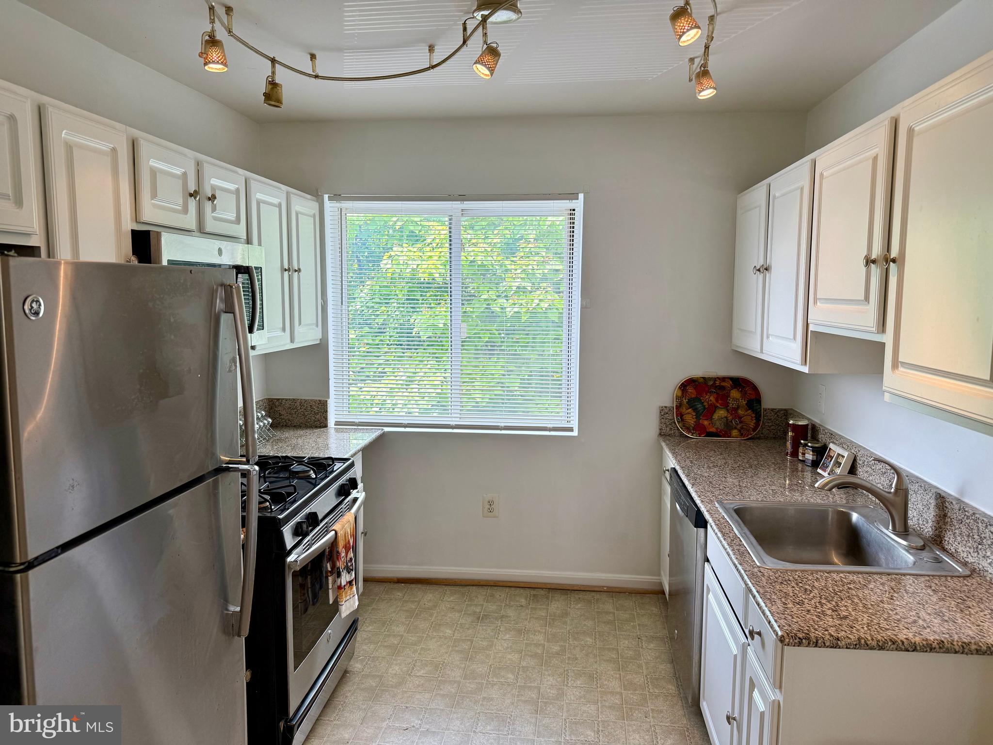4212 Benning Road Northeast, Unit 6 Washington, DC 20019 - Photo 9 of 21 a kitchen with stainless steel appliances granite countertop a refrigerator a sink a stove and a refrigerator