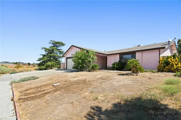 a view of a house with a yard and garage