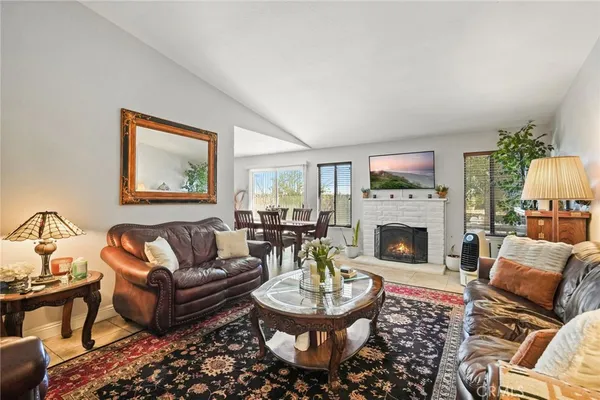 a living room with furniture a fireplace and a table