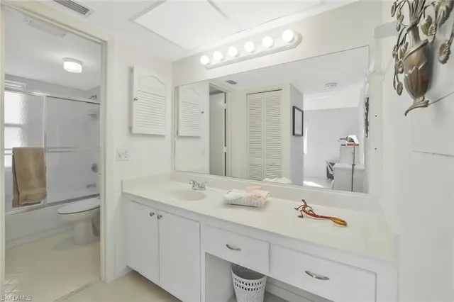 a bathroom with a sink double vanity and a mirror