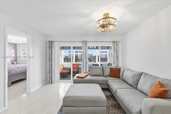 a living room with furniture and a chandelier
