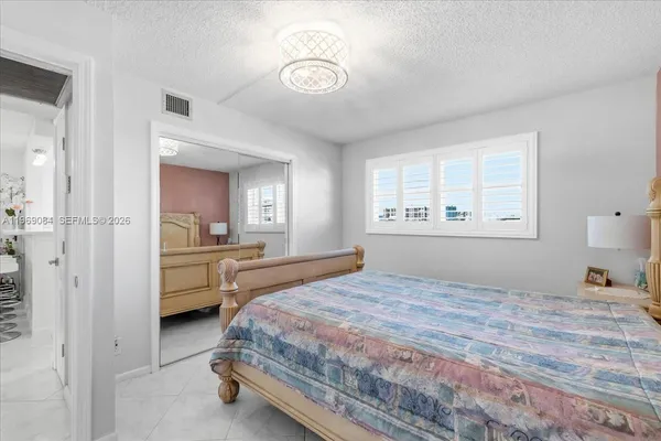 a bedroom with a bed and a closet with window