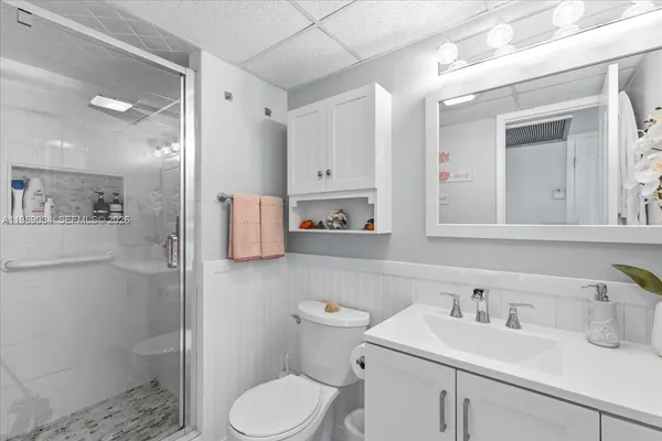 a bathroom with a sink toilet and shower