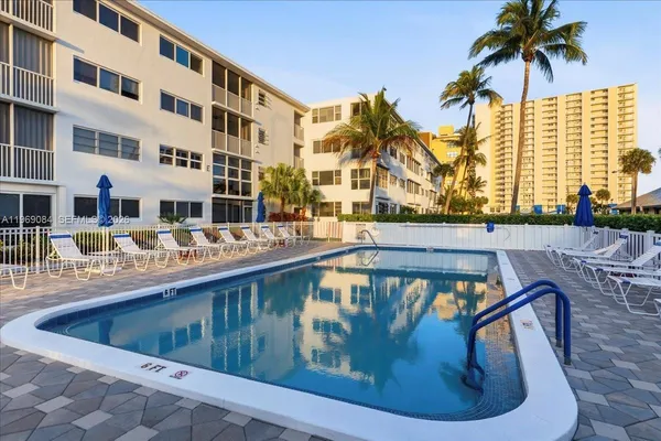 a view of a swimming pool with a lounge chair