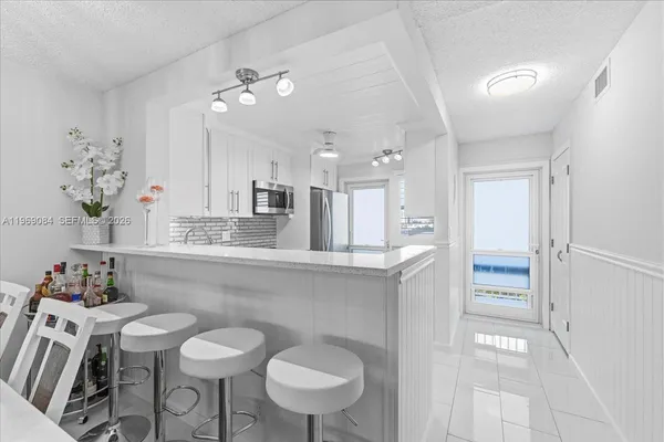 a kitchen with a table and chairs in it