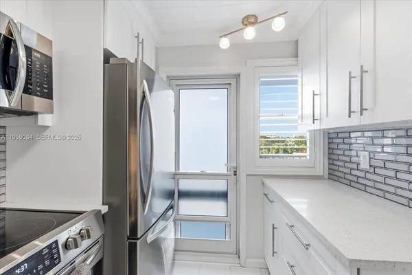 a kitchen with stainless steel appliances a refrigerator and a stove