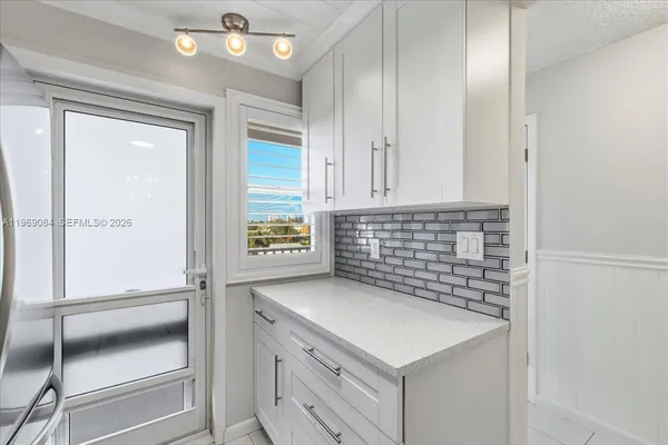 a kitchen with a sink and cabinets