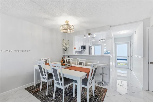 a view of a dining room with furniture and chandelier