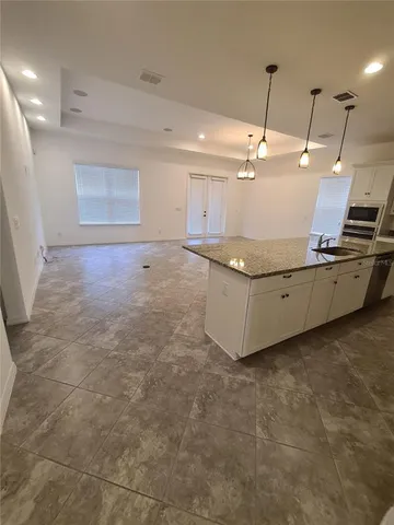 a living room with granite countertop furniture and a ceiling fan