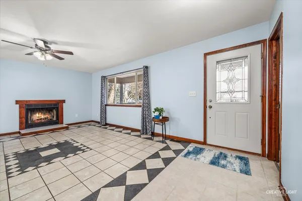 a bedroom with a bed and a lamp on dresser