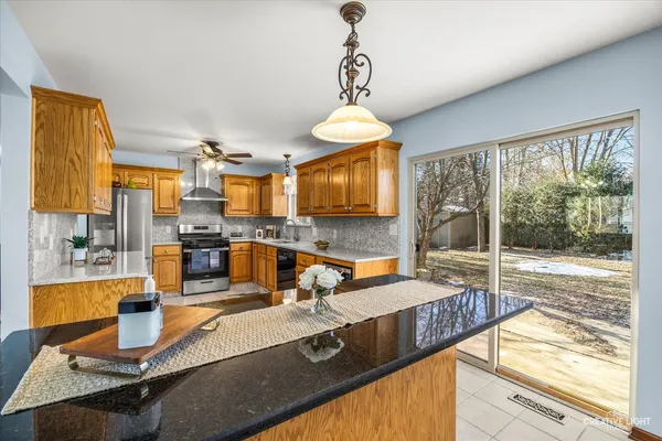 a kitchen with granite countertop a stove and a sink