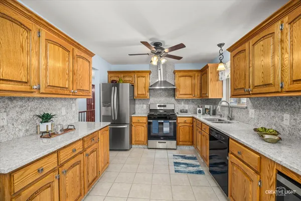 a kitchen with stainless steel appliances granite countertop a sink and cabinets