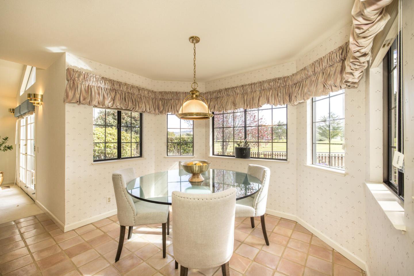 138 Cypress Point Road Half Moon Bay, CA 94019 - Photo 12 of 64 a dining room with furniture a chandelier and wooden floor