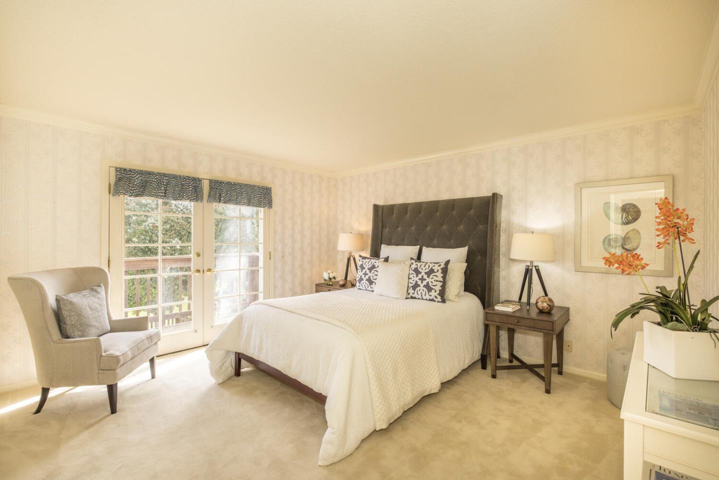 138 Cypress Point Road Half Moon Bay, CA 94019 - Photo 16 of 64 a bedroom with a bed and a couch next to a window