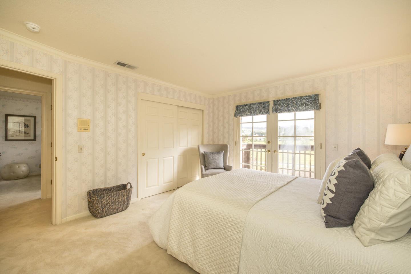 138 Cypress Point Road Half Moon Bay, CA 94019 - Photo 18 of 64 a bedroom with a bed and a couch