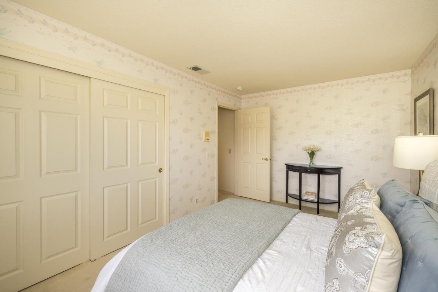 138 Cypress Point Road Half Moon Bay, CA 94019 - Photo 26 of 64 a bedroom with a bed and a table in it