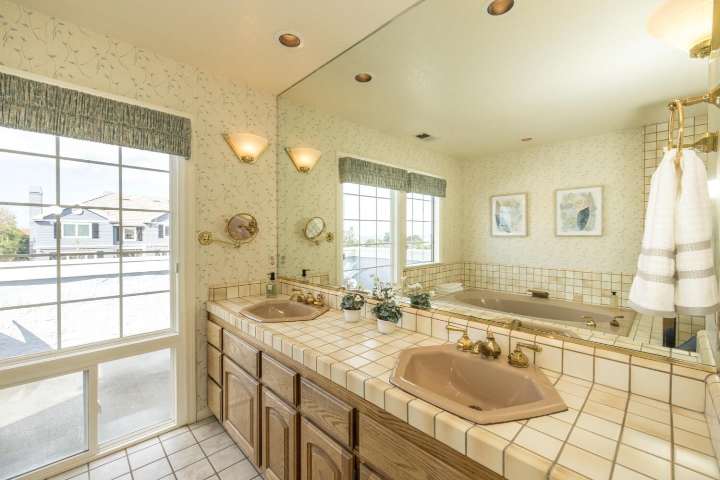 138 Cypress Point Road Half Moon Bay, CA 94019 - Photo 32 of 64 a bathroom with a granite countertop sink and a large mirror