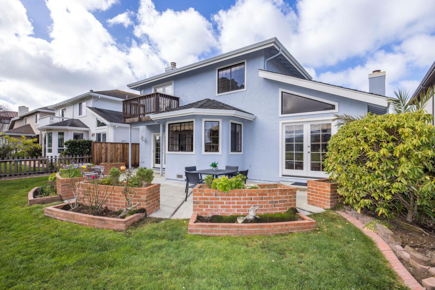138 Cypress Point Road Half Moon Bay, CA 94019 - Photo 58 of 64 a front view of a house with a yard table and chairs