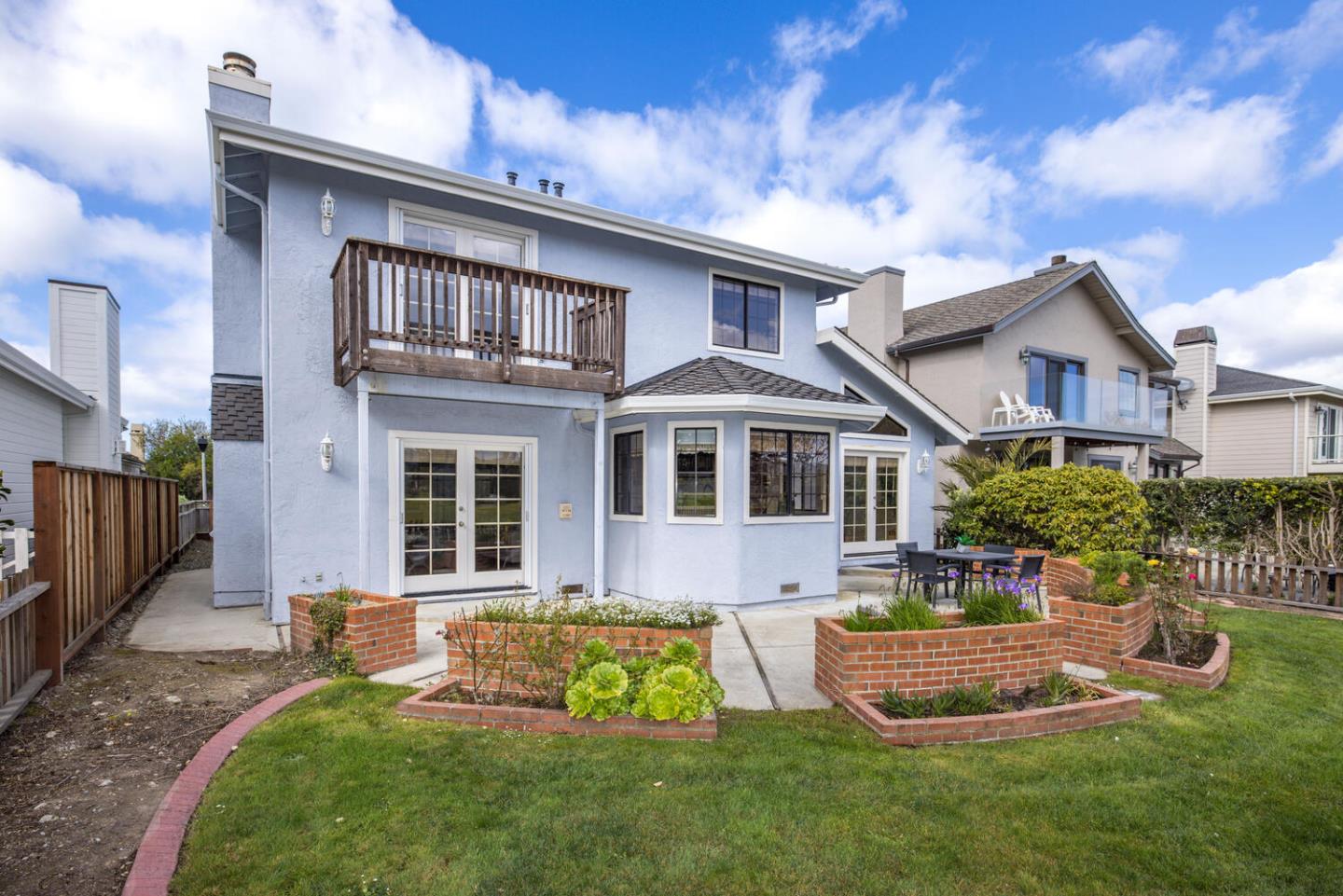 138 Cypress Point Road Half Moon Bay, CA 94019 - Photo 63 of 64 a front view of a house with a yard table and chairs