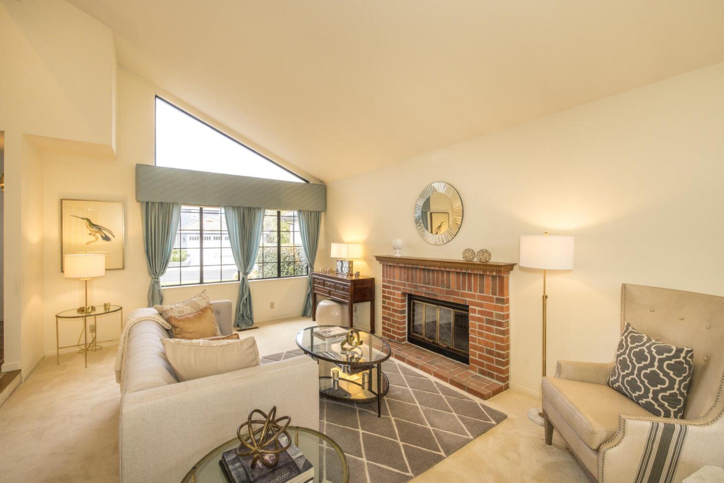 138 Cypress Point Road Half Moon Bay, CA 94019 - Photo 8 of 64 a living room with furniture a fireplace and a flat screen tv