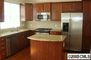 672 6th Baxter Crossing, Unit 1802 Fort Mill, SC 29708 - Photo 5 of 7 a kitchen with stainless steel appliances granite countertop a sink a microwave a refrigerator and cabinets