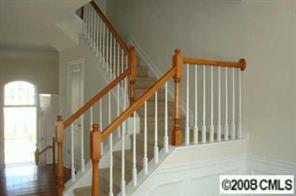 672 6th Baxter Crossing, Unit 1802 Fort Mill, SC 29708 - Photo 7 of 7 a view of staircase with lots of frames on wall and a window