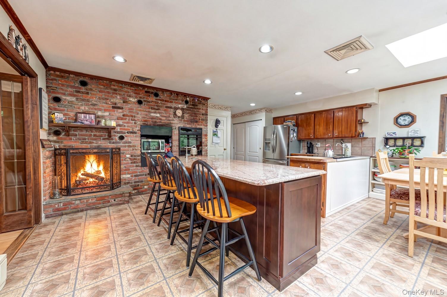 118 Harbor Road St. James, NY 11780 - Photo 5 of 18 EIK with dual fireplace into living room