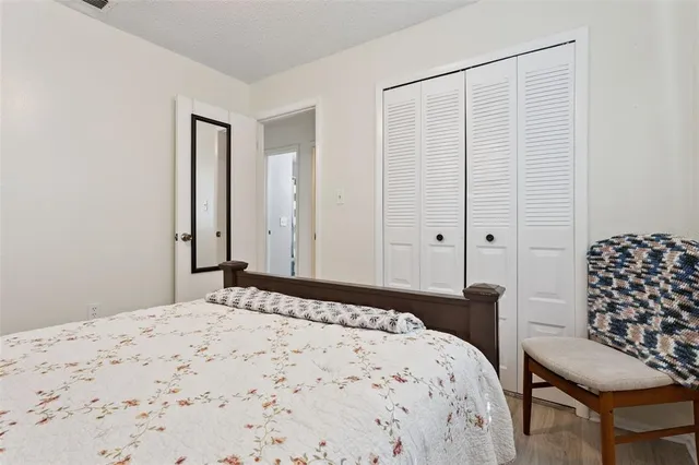 a bedroom with a bed and a chair