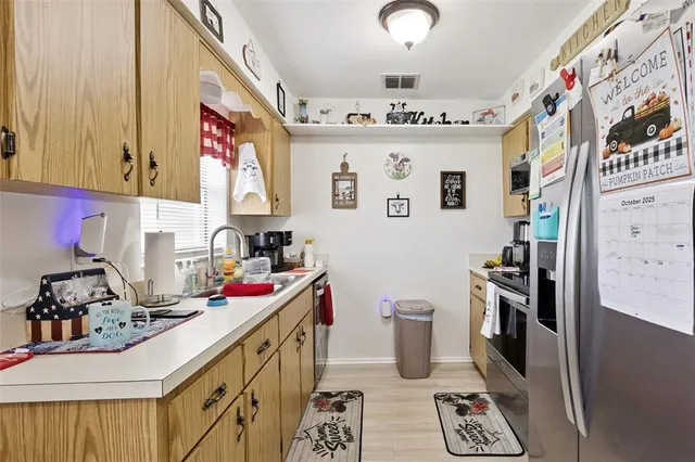 a kitchen with stainless steel appliances granite countertop a sink and a stove