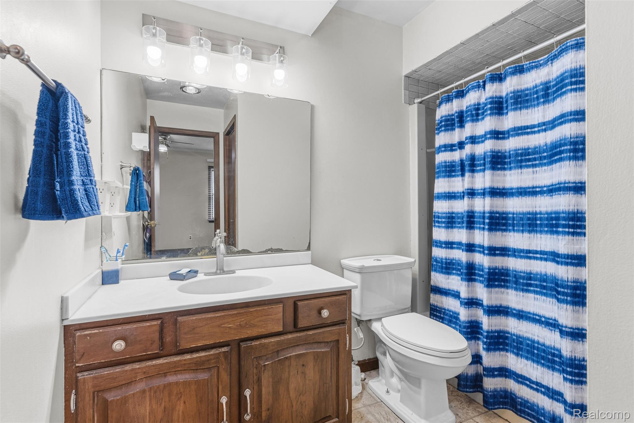 3432 South State Road Davison, MI 48423 - Photo 20 of 58 Full bath with vanity, a shower with shower curtain, and light tile patterned floors