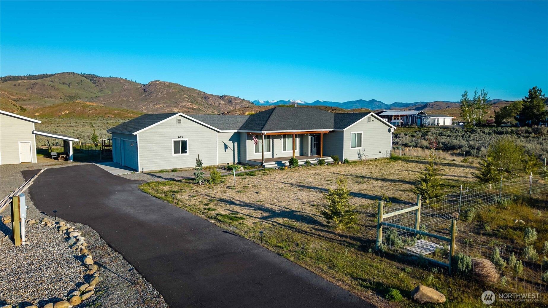 103 Johnson Creek Road Omak, WA 98841 - Photo 11 of 40 a view of a house with a yard and mountain view