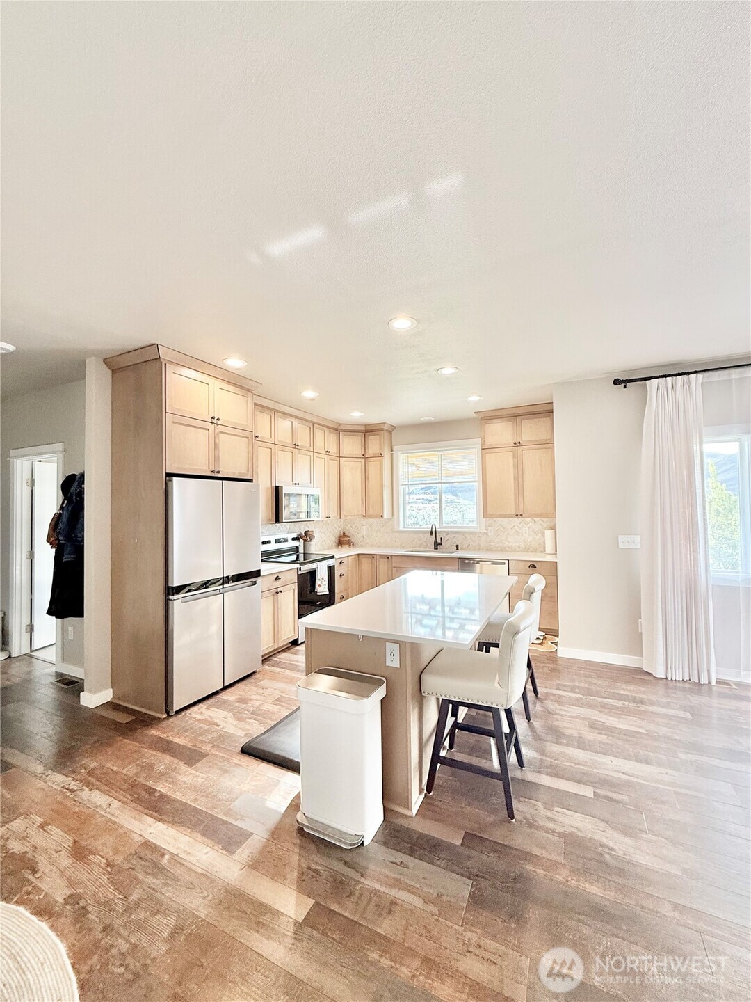 103 Johnson Creek Road Omak, WA 98841 - Photo 18 of 40 a dining hall with stainless steel appliances kitchen island granite countertop a dining table chairs and a refrigerator