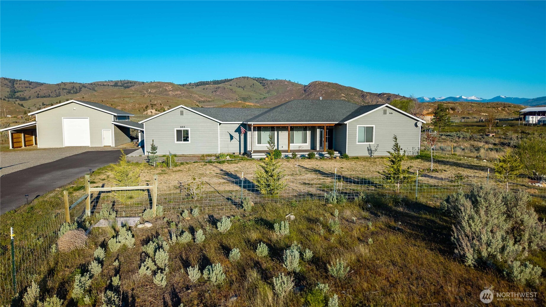 103 Johnson Creek Road Omak, WA 98841 - Photo 2 of 40 a view of a big house with a big yard and large trees