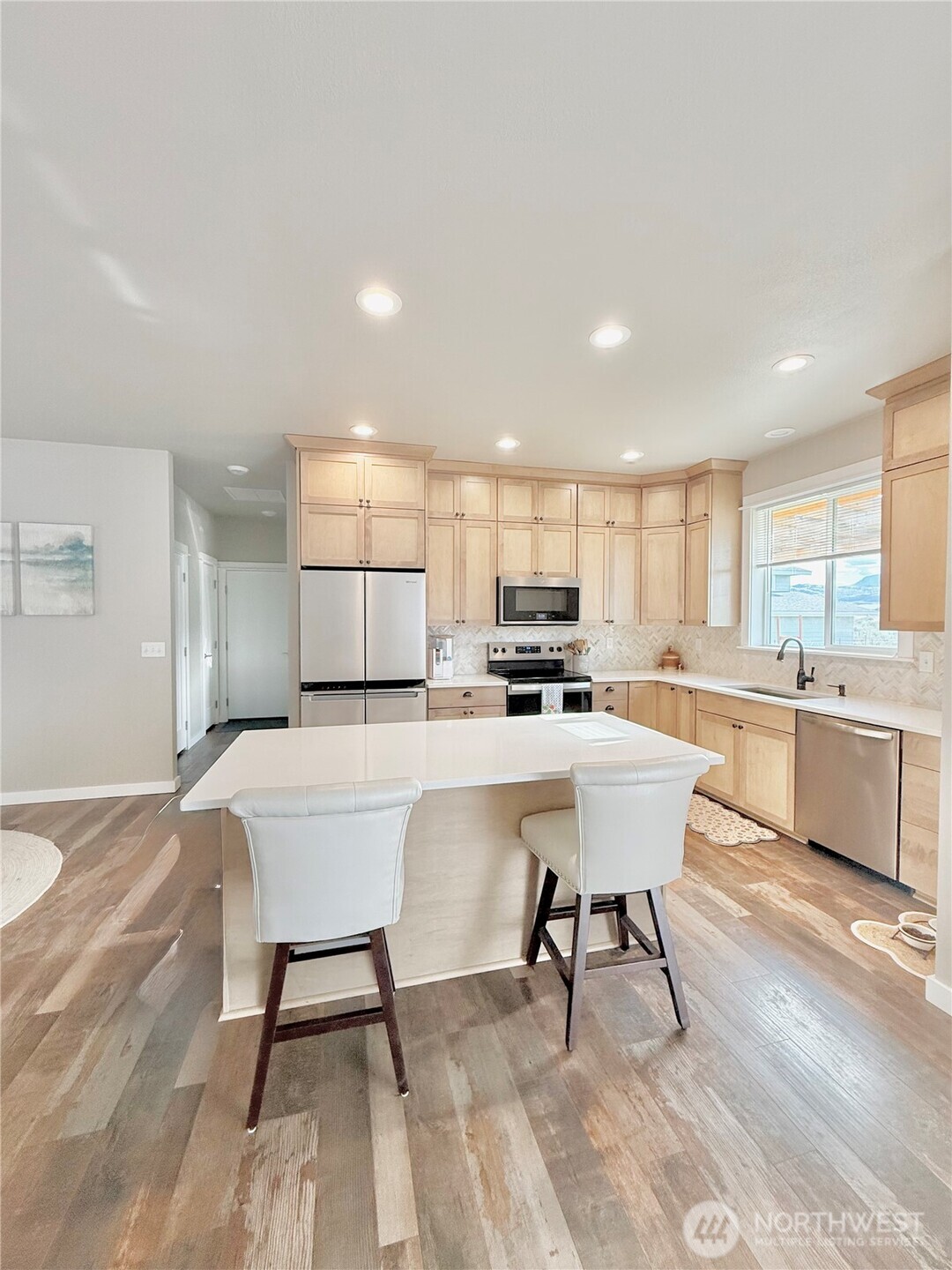 103 Johnson Creek Road Omak, WA 98841 - Photo 23 of 40 a kitchen with a sink cabinets and wooden floor