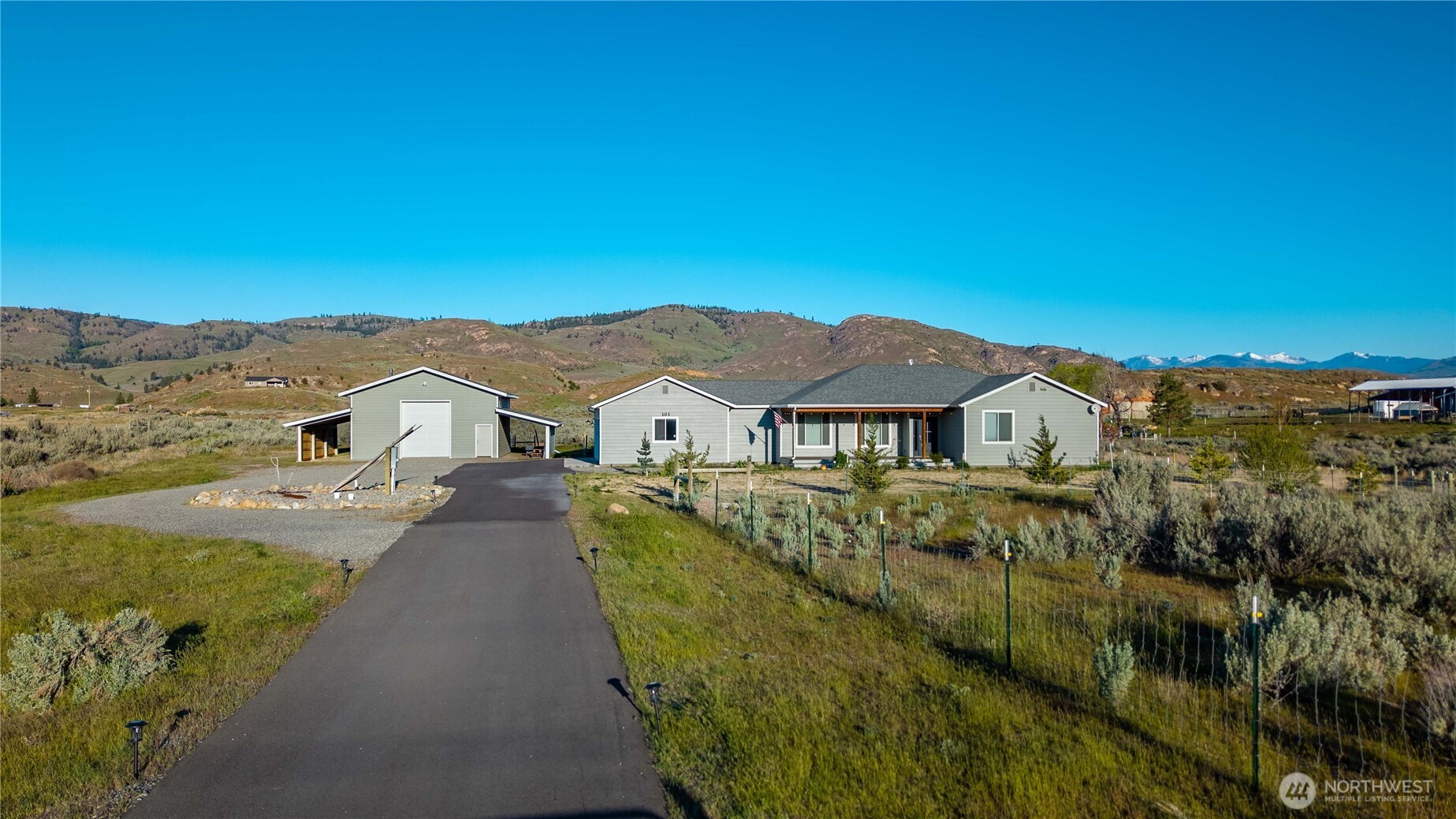 103 Johnson Creek Road Omak, WA 98841 - Photo 9 of 40 a view of a houses with a big yard and large tree