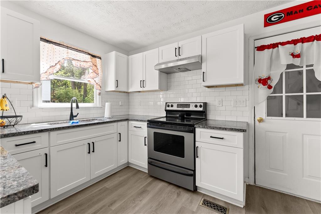 322 Wyngate Road Auburn, GA 30011 - Photo 17 of 44 a kitchen with white cabinets appliances and a window